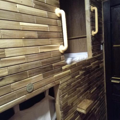 a brick wall in a bathroom with a shower at VNJ Capsule 388 in Hoi An