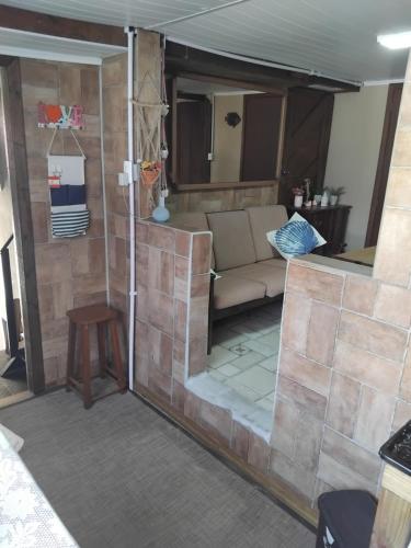 a living room with a couch and a table at Kitinete Ubatuba vista mar in São Francisco do Sul