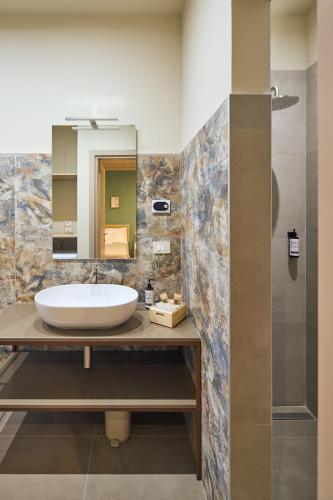 a bathroom with a sink and a mirror at Antico N19 in Passirano