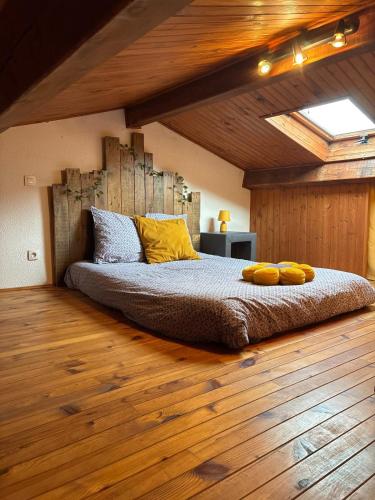 a bedroom with a bed with yellow pillows on it at La parenthèse ardéchoise in Le Pouzin