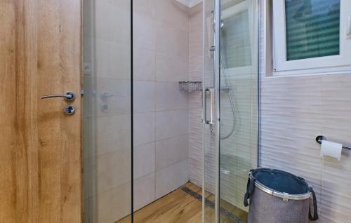 a shower with a glass door in a bathroom at Villa Hemingway beachfront by Villas Guide in Velika Plana