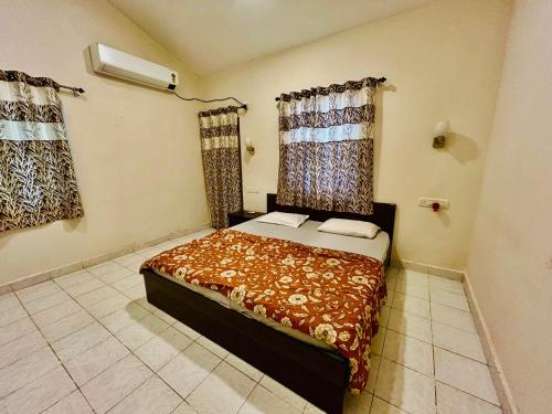 a bedroom with a bed in a room at The golden villa in Calangute