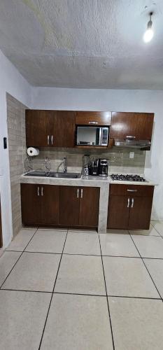 a kitchen with a sink and a microwave at Depa Santiago - Arena Guadalajara in Guadalajara