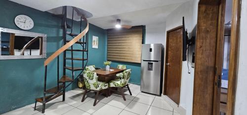 a kitchen with a table and a refrigerator at Depa Santiago - Arena Guadalajara in Guadalajara