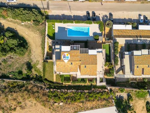 an overhead view of a building with a swimming pool at AffittaSardegna-Casa Pesca in Cascabraga