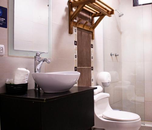 a bathroom with a sink and a toilet at Hotel Presidente Beach Salinas in Salinas