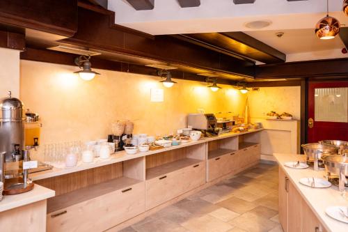 a large kitchen with wooden counters and appliances at Kopernikus Hotel Prag in Belgrade