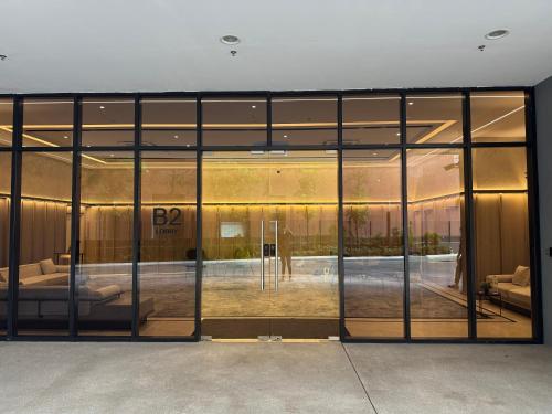 a large glass door of a building with a pool at KLCC Agile Sky villa Residences in Kuala Lumpur