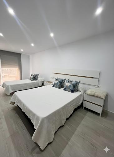 a bedroom with two beds and a couch at Casa moderna en Manises con 2 terrazas in Manises