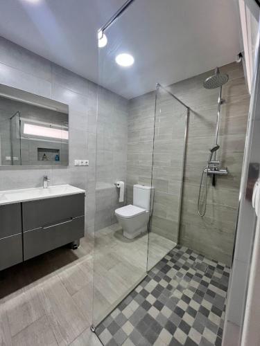 a bathroom with a toilet and a sink and a shower at Casa moderna en Manises con 2 terrazas in Manises