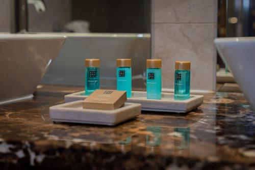 a group of three bottles of toothpaste on a counter at George Limerick Hotel in Limerick