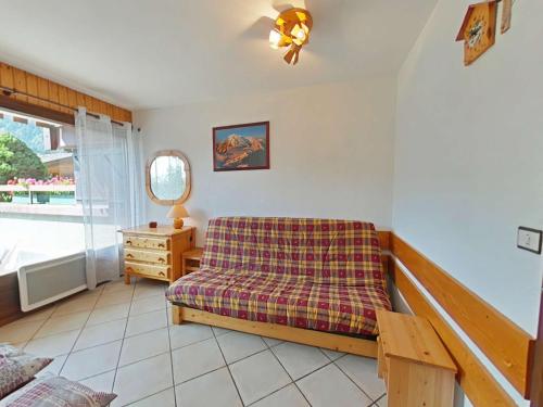 a living room with a couch and a table at Studio ski aux pieds avec terrasse, parking et Wi-Fi - 4 couchages - FR-1-241-173 in Le Grand-Bornand