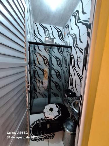 a hallway with a room with a wall with black and white wallpaper at Casa de Praia in Mosqueiro