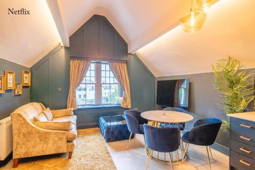 a living room with a couch and a table at The Rockefeller Apartments in Bowness-on-Windermere