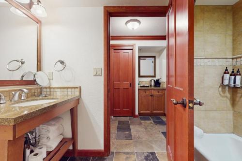 a bathroom with a tub and a sink and a shower at Everline Resort & Spa 317 in Olympic Valley