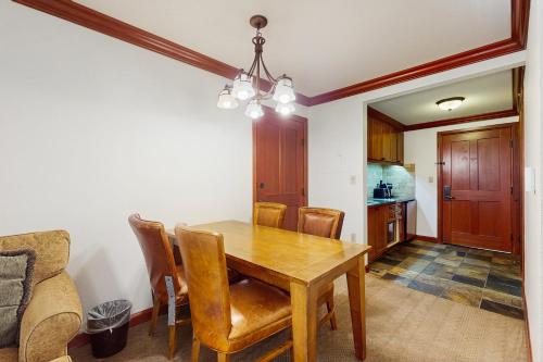 a dining room with a wooden table and chairs at Resort at Squaw Creek's 319 in Olympic Valley