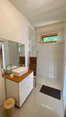 a bathroom with a sink and a mirror at Mimpi Manis Villas in Tetebatu