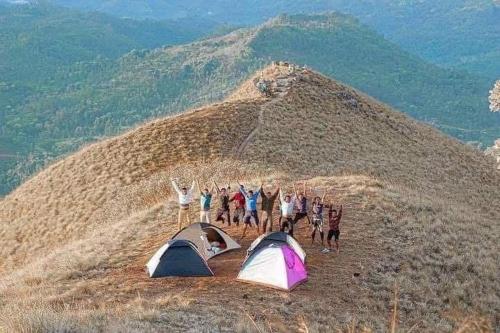 a group of people standing on top of a hill with tents at narangala skycamping 
