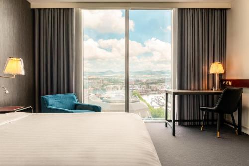 a hotel room with a bed and a large window at Radisson Blu Hotel, Bristol in Bristol