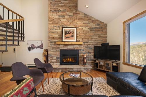 a living room with a fireplace and a tv at Snowblaze Condos Building A unit 33 in Winter Park