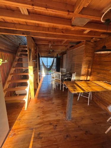 a large room with wooden floors and a wooden table at Cabaña soles in Manuel Alberti
