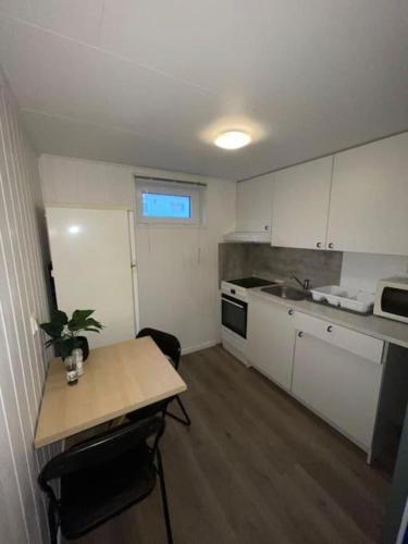 a small kitchen with a table and a sink at Tromsdalen Studio 2 - FREE Parking, Views & Quiet Area in Trondalen