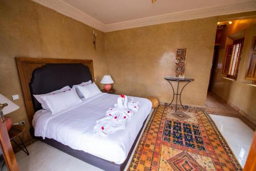 a bedroom with a bed with towels on it at Domaine 3 Riads in Marrakech