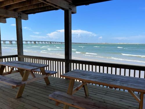 two picnic tables on a porch overlooking the beach at Atlantis - Oceanfront Seating at its Finest! in Freeport