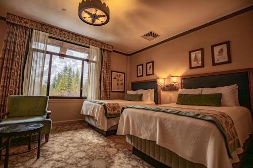 a hotel room with two beds and a window at The Ahwahnee in Yosemite Village