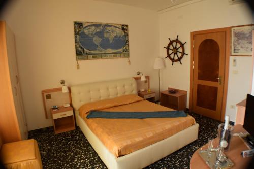 a bedroom with a bed in a room with a desk at Hotel Rosa Meublé in Porto San Giorgio