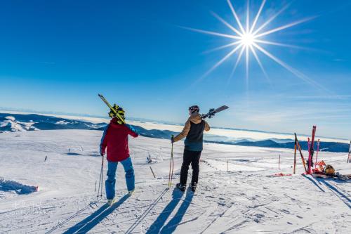two people standing on top of a snow covered slope with skis at Altes Forsthaus - Fewo "Hasenhorn", mit privater Sauna, Todtnau- Feldberg in Todtnau