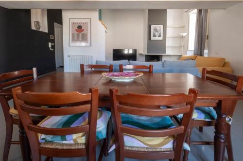 a dining room with a wooden table and chairs at San Lorenzo by the sea in Augusta