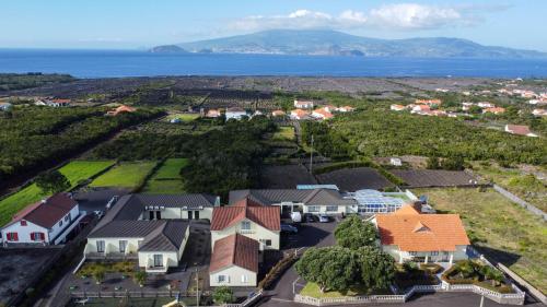 an aerial view of a village with houses and the ocean at AL Novavista by A5P in Madalena