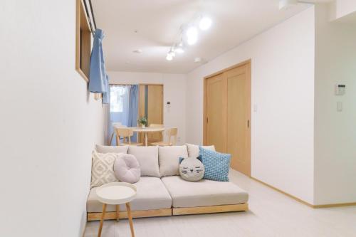 a living room with a white couch and a table at Sion OSU in Nagoya