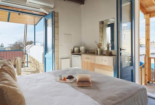 a room with a bed with a plate of food on it at Maisonette at The Olive Manor in Peristerona
