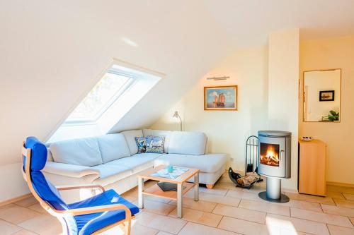 a living room with a couch and a fireplace at Ferienhaus LampRieger Fewo 1 OG in Wieck