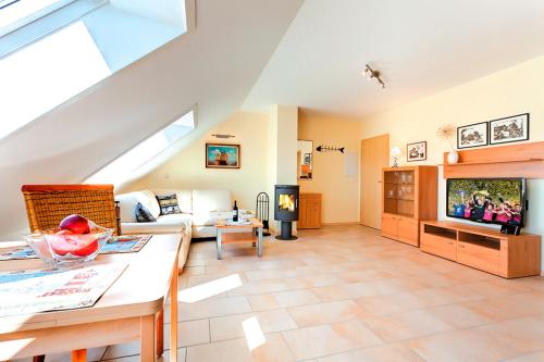 a living room with a couch and a tv at Ferienhaus LampRieger Fewo 1 OG in Wieck