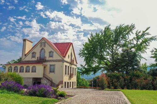 a house with a red roof and a driveway at The Luxury and Nature Retreat with pool, jacuzzi & BBQ in Vila Fonche