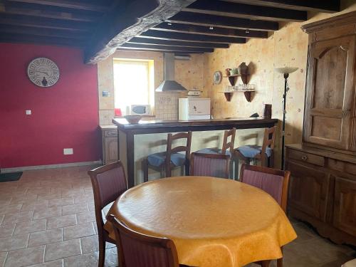 a dining room with a wooden table and chairs at Chez Pauline in Grimault