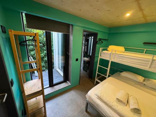 a room with two bunk beds and a window at Sardines and Friends Hostel 06 in Póvoa de Varzim