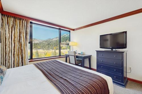 a bedroom with a bed and a flat screen tv at Resort at Everline Resort & Spa #558 in Olympic Valley