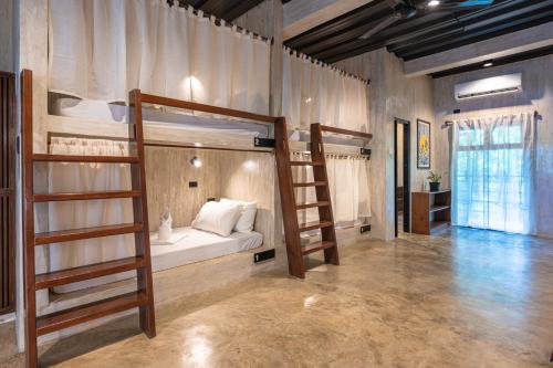 a room with two bunk beds and a ladder at Anantha Wellness Sanctuary in General Luna