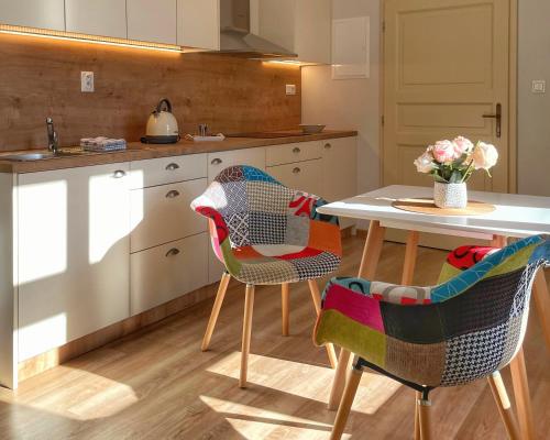 a kitchen with a table and two chairs at Apartmány Bašta & Wellness in Sušice