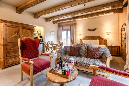 a living room with a couch and chairs in a room at The Alpenhof in Teton Village