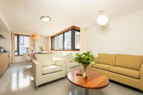 a living room with a couch and chairs and a table at The Quigley Residence in Limerick