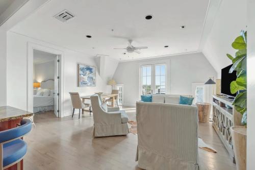 a living room with a couch and a table and chairs at Elegant Three Bedroom Condo Near Rosemary Beach in Rosemary Beach