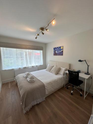 a bedroom with a bed and a desk and a chair at King Room in Windsor with Private Bathroom in Windsor