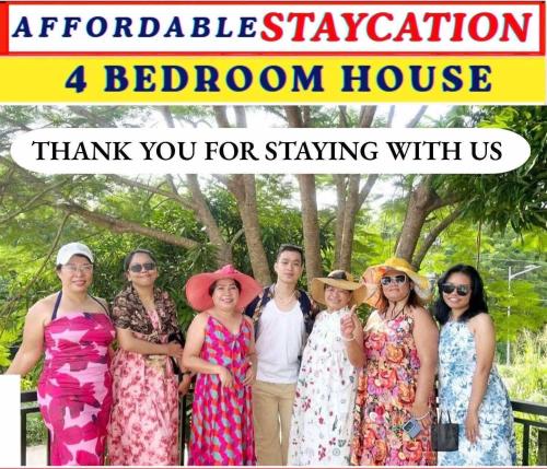 a group of people posing for a picture in a room at Aladdin's Guest House in Coron