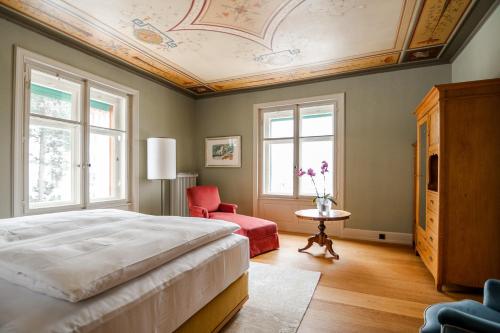 a bedroom with a bed and a coffered ceiling at Villa Klainguti in Pontresina