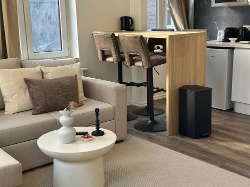 a living room with a couch and a table at Lovely 1BR & 1LR Apartment, Only 15 Min Walk to City Center in Ghent